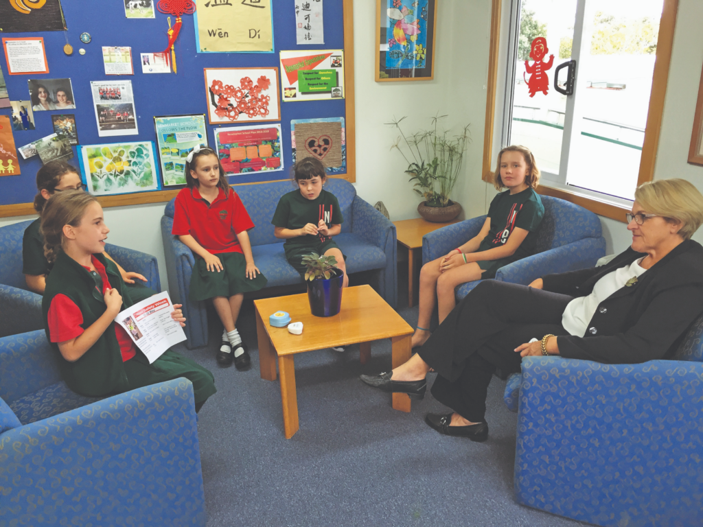 Newmarket Primary students sitting with principal